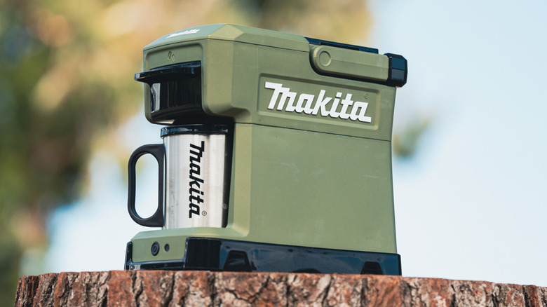 Makita coffee maker sitting on cut log