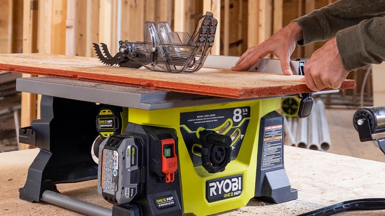 Peson cutting wood on Ryobi table saw