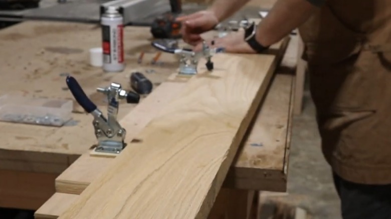 Person attaching board to jointer jig