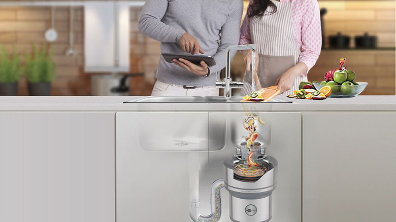 Two people putting food down a garbage disposal with a graphic showing the disposal.
