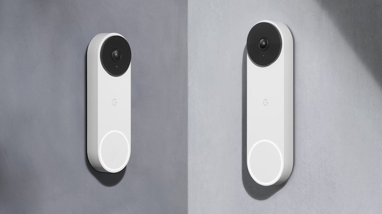 A pair of Google Nest doorbells hanging on gray wall