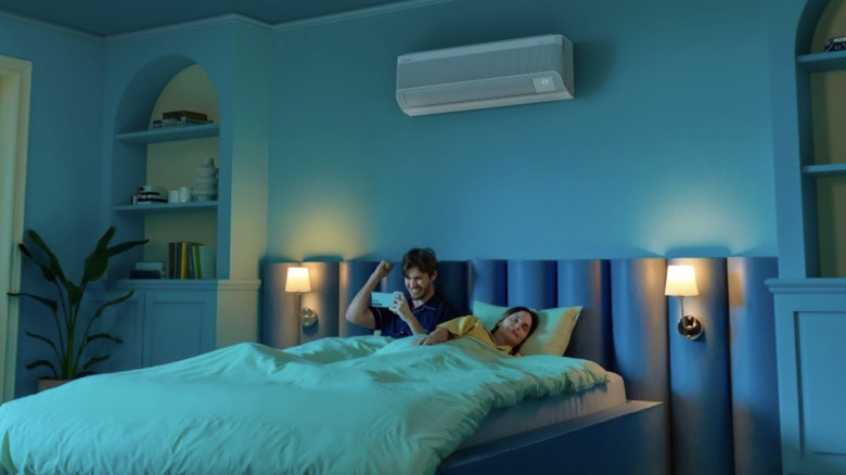 couple on bed with man on his phone