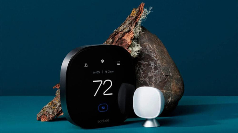 An Ecobee thermostat next to a censor and an unknown object