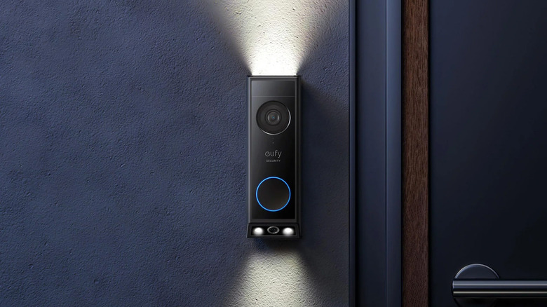 A Eufy E340 Video Doorball at night with lights on