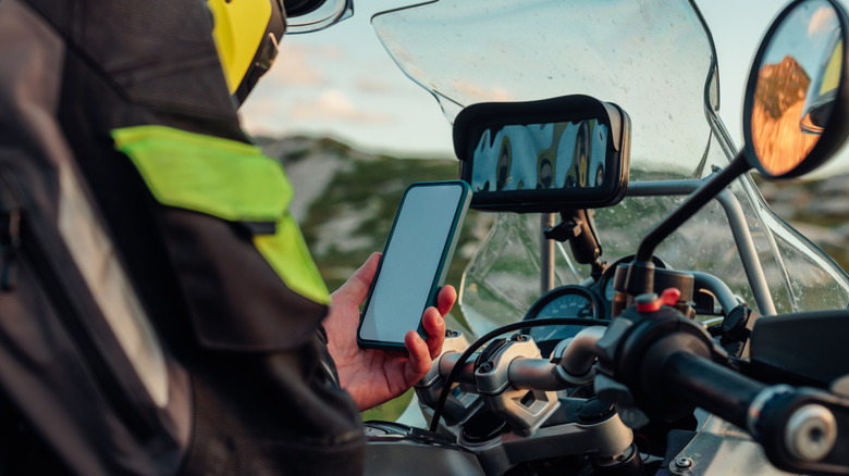A biker with phone in his hands