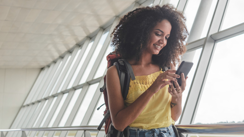 A traveler checking her phone