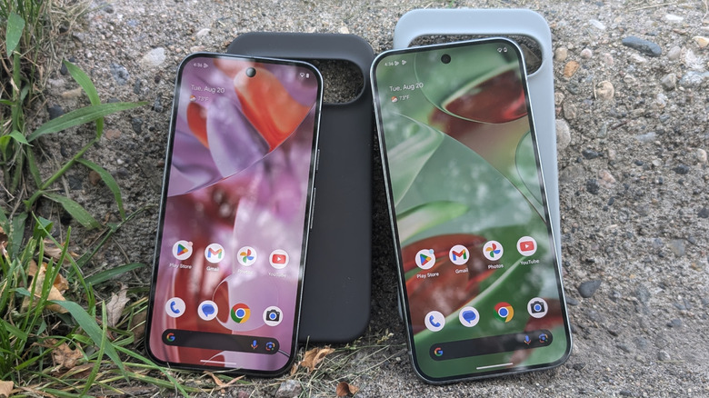 Two Google Pixel phones standing against their cases on concrete background