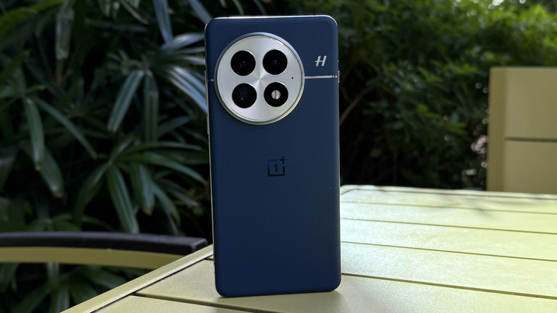 OnePlus 13 phone standing on table