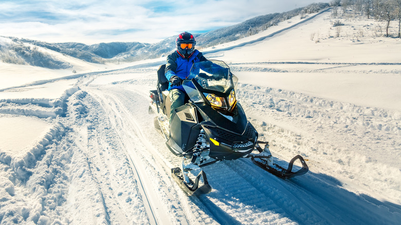 Person riding snowmobile