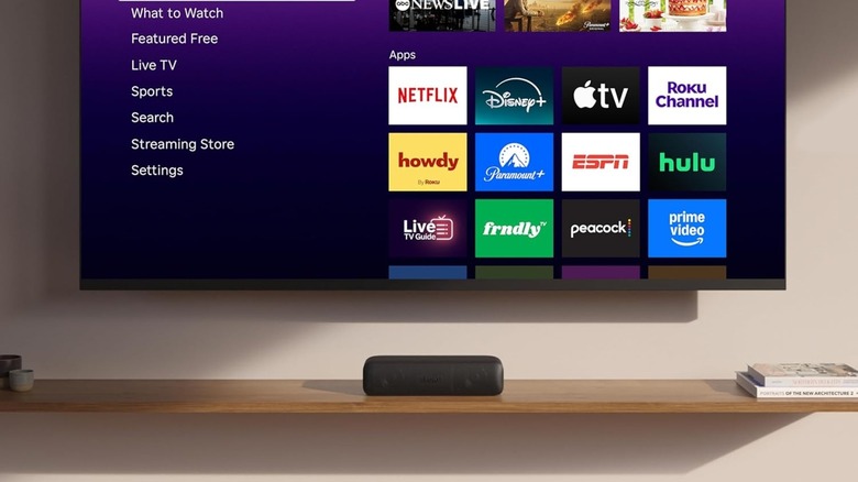 Roku Streambar set up under a Roku TV