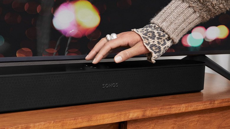Hand atop a black Sonos Beam Gen 2 soundbar