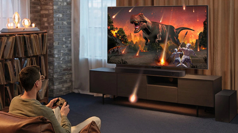 Person gaming on a TV with a Samsung HW-Q600C soundbar setup