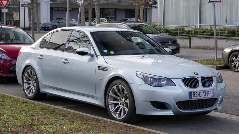 A silver E60 BMW M5 parked in a parking lot.