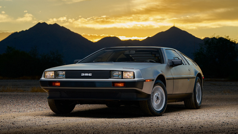 DeLorean DMC-12 parked front 3/4 view at sunset