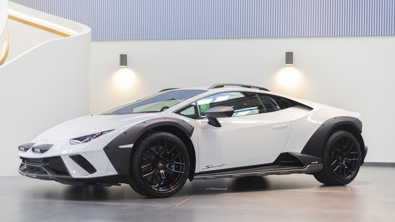 A white Lamborghini Huracan with gray details, front 3/4 view