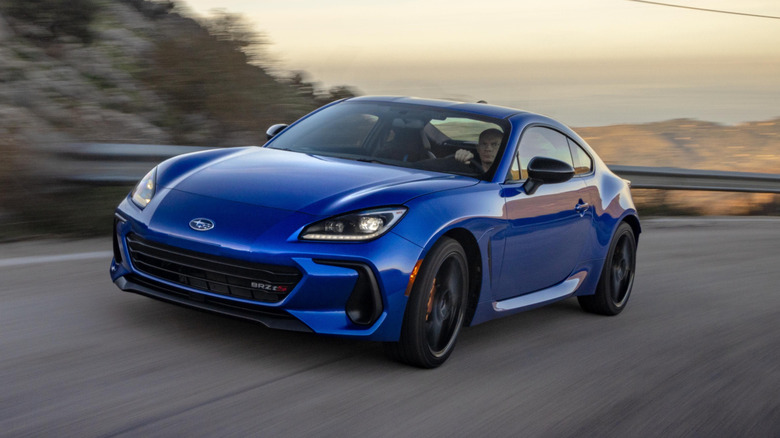 Front 3/4 view of blue Subaru BRZ on mountain road.