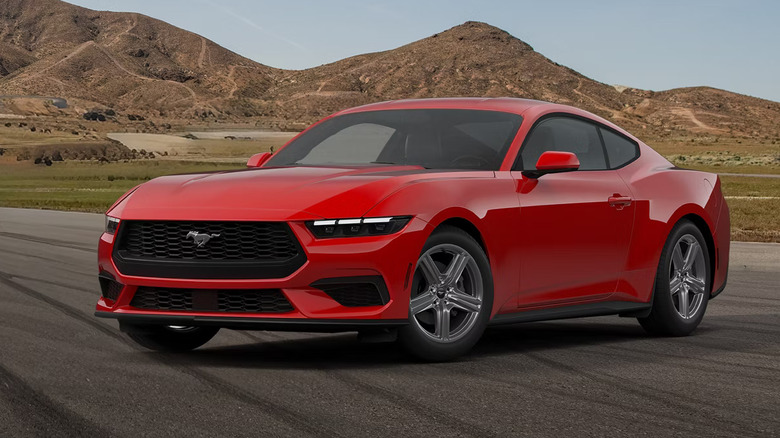 Ford Mustang EcoBoost parked near the mountains, front 3/4 view, red exterior
