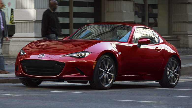 Mazda Miata in the city, front 3/4 view, red exterior