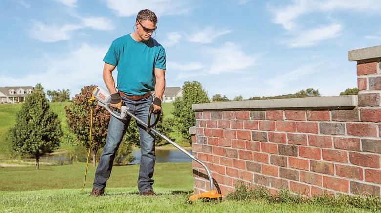 Man using Stihl FSE 60 Grass Trimme in a garden.