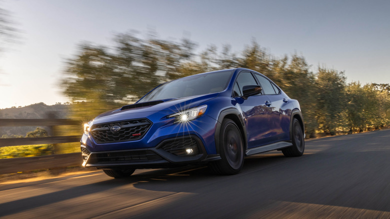2025 Subaru WRX tS on the move, front 3/4 view, blue exterior