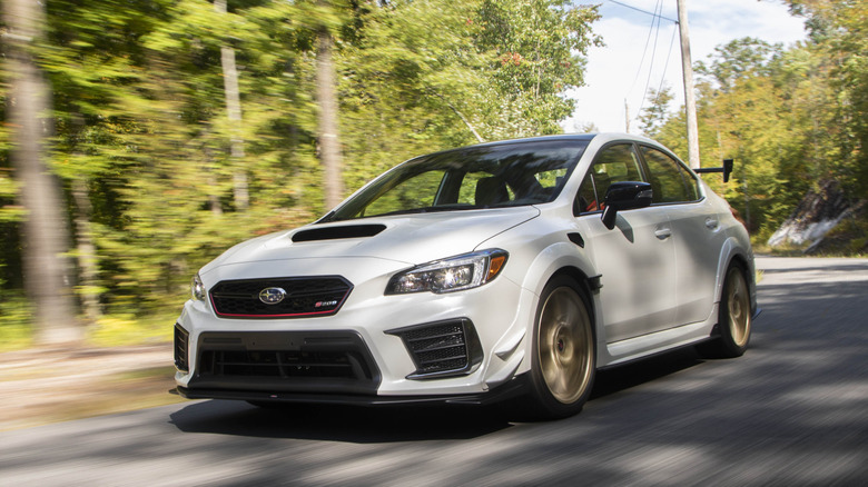 Subaru STI S209 on the move, white exterior, front 3/4 view
