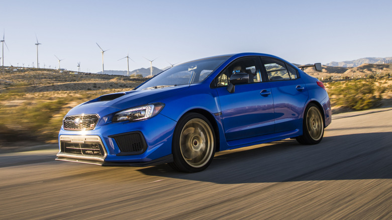A blue Subaru WRX STI Type RA on the move, front 3/4 view