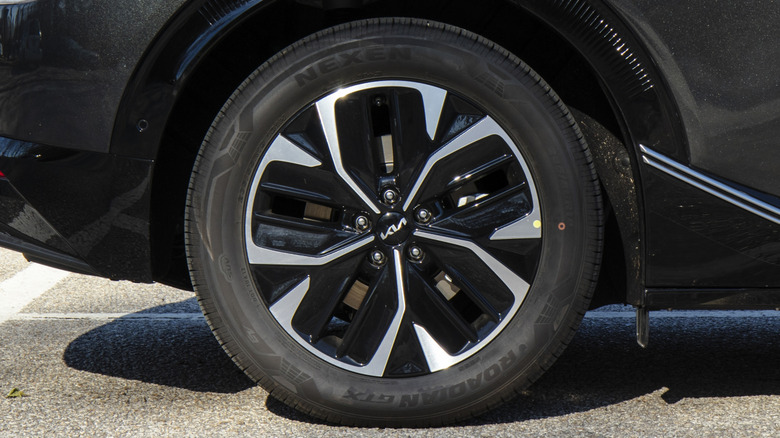 A Kia EV6 wearing Nexes tires on its right rear corner.