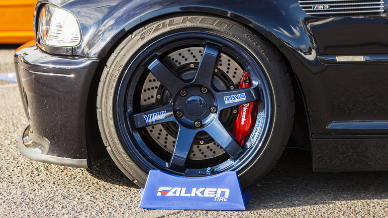 A tuned dark-blue E46 BMW M3 wearing Falken tires.
