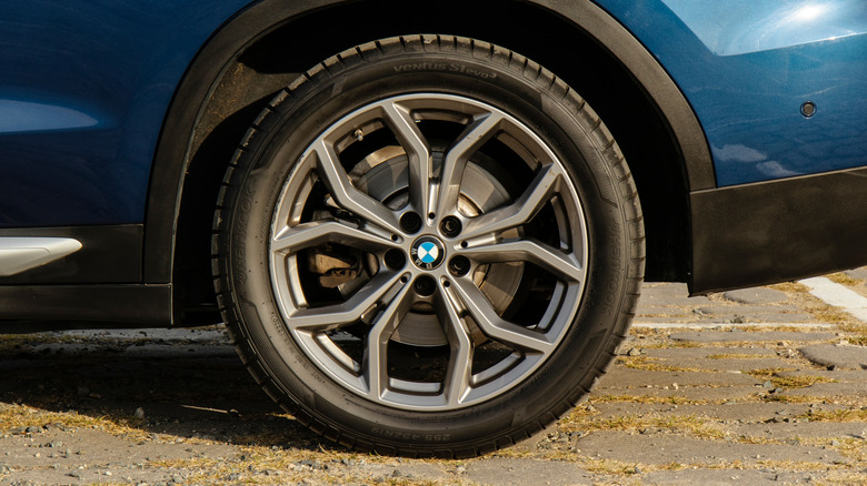A blue BMW SUV wearing a Hankook Ventus tire.