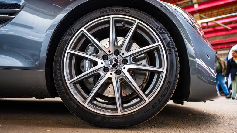 A light blue Mercedes sports car wearing a Kumho ECSTA tire.