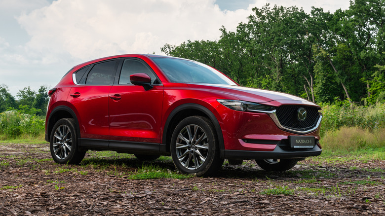 Mazda CX-5 sitting on a dirt track in the countryside.
