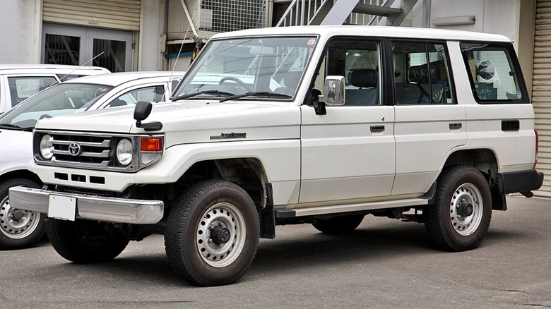 a white Toyota Land Cruiser J70 in a parking lot