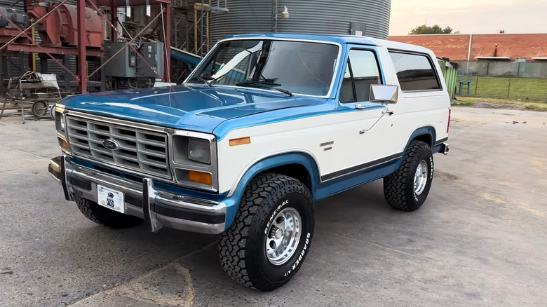 A side on shot of a white and blue 1982 Ford Bronco