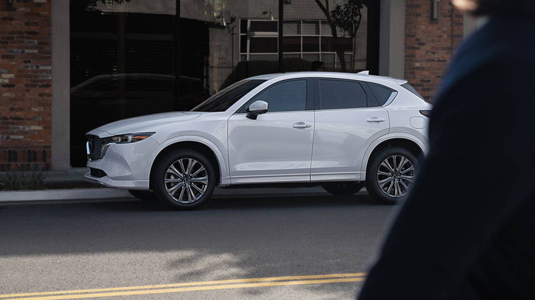 A white Mazda CX-5 parked on a city street