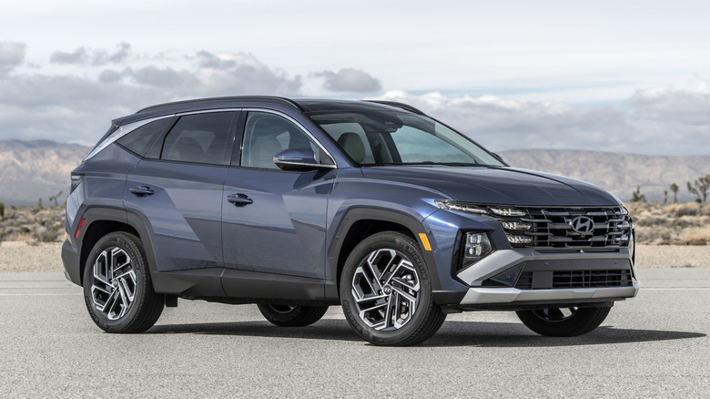 Blue Hyundai Tucson parked on a road in a barren desert