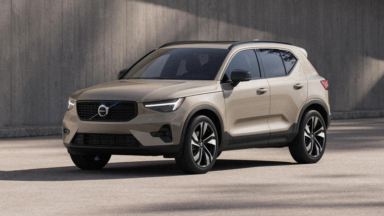Tan 2026 Volvo XC40 parked in front of a concrete building