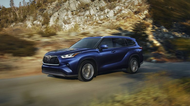 A blue Toyota Highlander driving