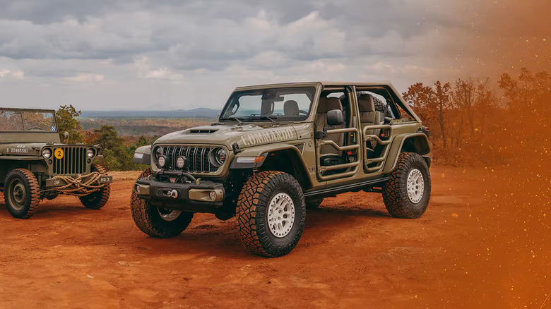 A brown Jeep with the doors taken off in a sandy area.
