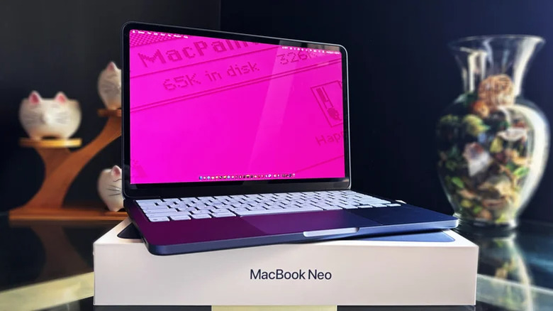 Open MacBook Neo placed atop its packaging box