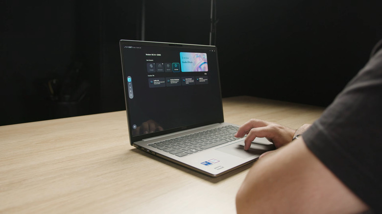 A person using the MSI Modern 14S AI+, side view