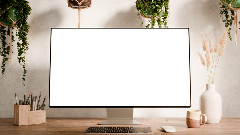 A computer monitor with a white screen on a table
