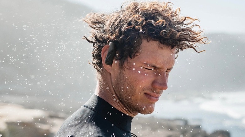 Surfer wearing JBL Endurance Peak 3 earbuds