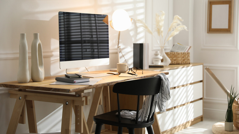 A home workspace with a desktop computer sitting on a modern desk