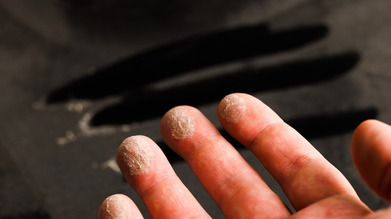 Person with dust on fingertips wiped from the back of the TV