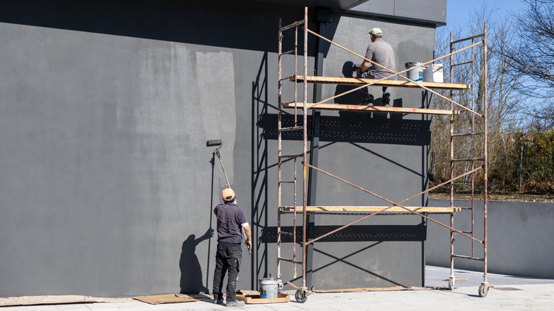 Painters using scaffolding outdoors