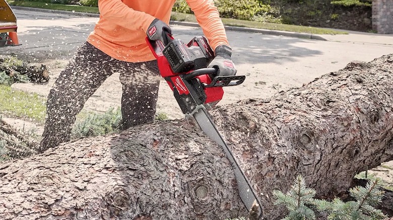 Person using Milwaukee Tools chain saw