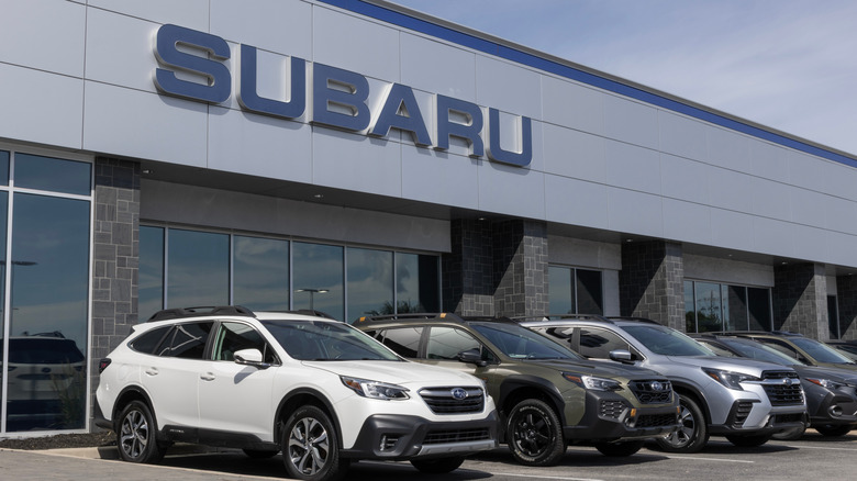 A Subaru showroom with cars parked in front