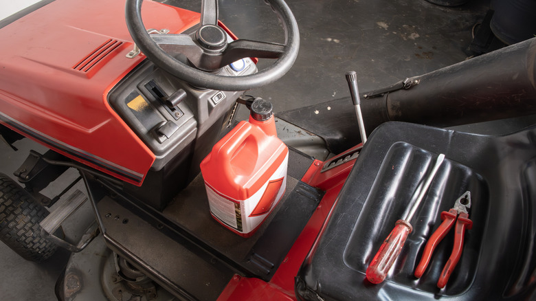 bottle of engine oil on riding mower