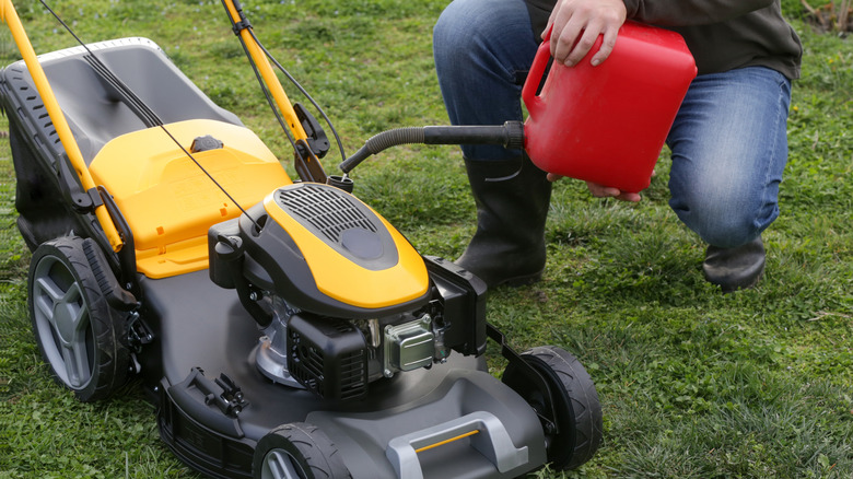 adding fuel to lawn mower