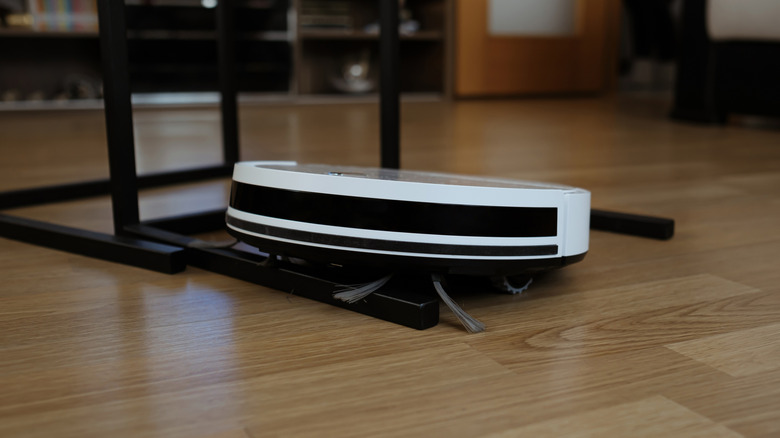A robot vacuum stuck on a table leg